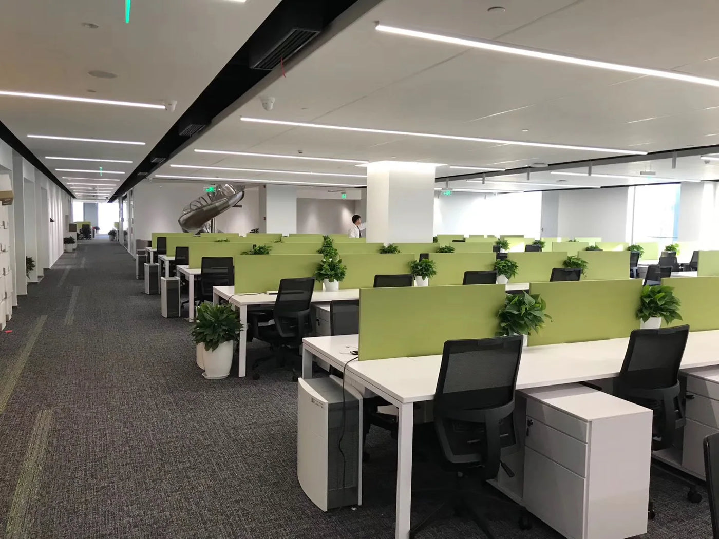 Open-plan office with green partition workstations